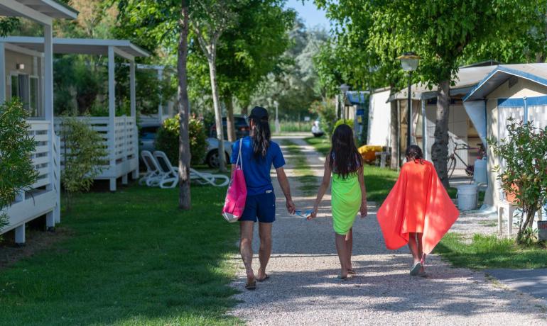 Famiglia cammina in campeggio, giornata estiva.